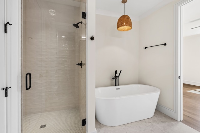 bathroom featuring independent shower and bath, crown molding, and wood-type flooring