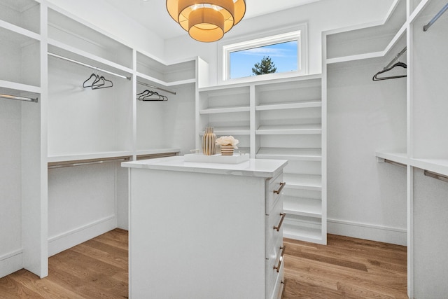 walk in closet featuring light hardwood / wood-style flooring