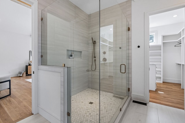 bathroom with walk in shower and wood-type flooring