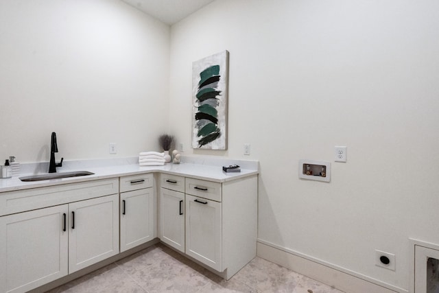 laundry area featuring washer hookup, hookup for an electric dryer, light tile patterned floors, cabinets, and sink