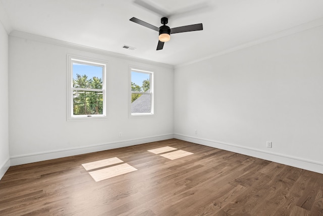 empty room featuring ceiling fan, ornamental molding, and hardwood / wood-style floors