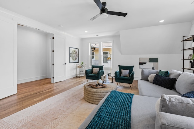 living room featuring ceiling fan and hardwood / wood-style floors