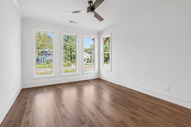 unfurnished room with ornamental molding, dark hardwood / wood-style floors, and ceiling fan