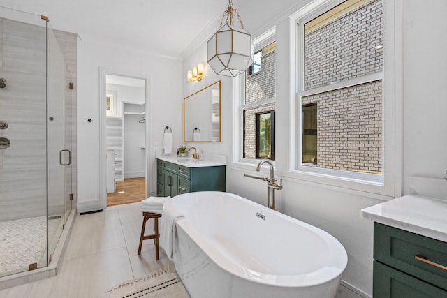 bathroom with ornamental molding, shower with separate bathtub, tile patterned flooring, and vanity