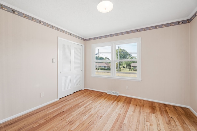 spare room with light hardwood / wood-style floors