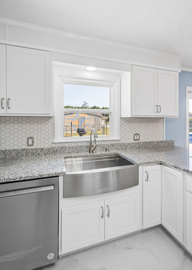 kitchen with dishwasher, sink, and white cabinetry