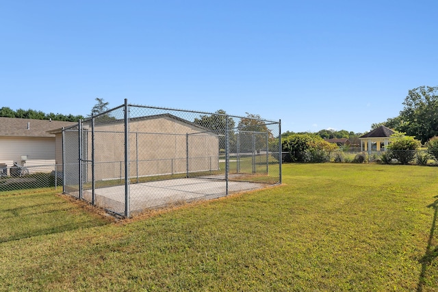 view of basketball court with a yard