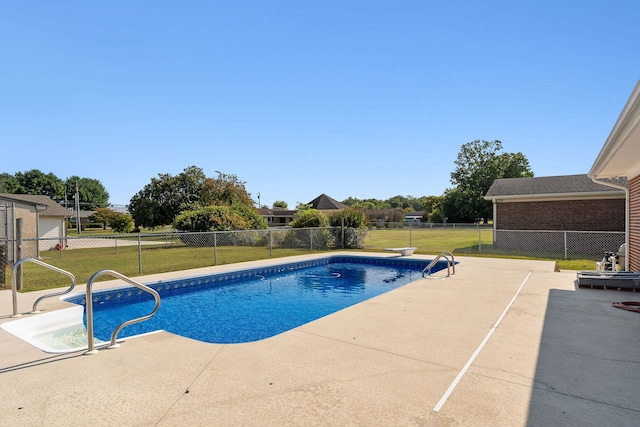 view of swimming pool featuring a lawn and a patio