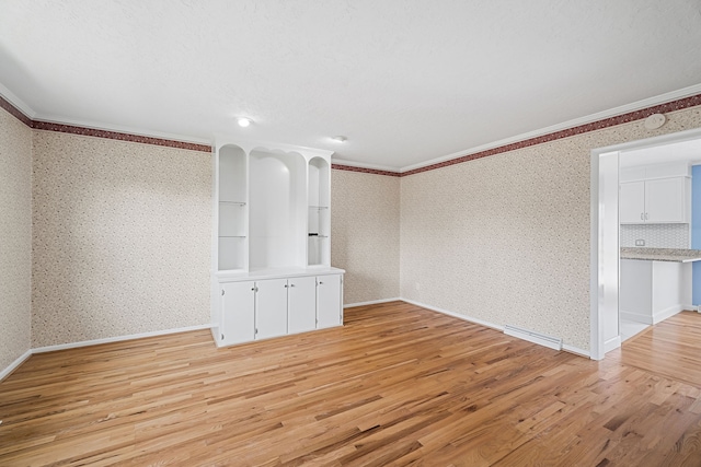 unfurnished room with ornamental molding and light hardwood / wood-style floors