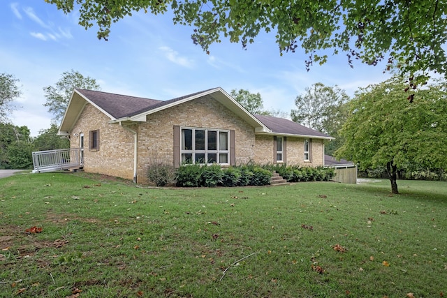 view of side of home with a lawn