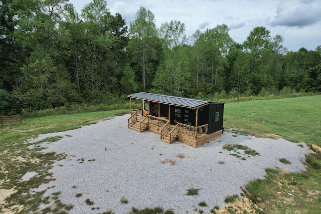 exterior space featuring a lawn and a porch