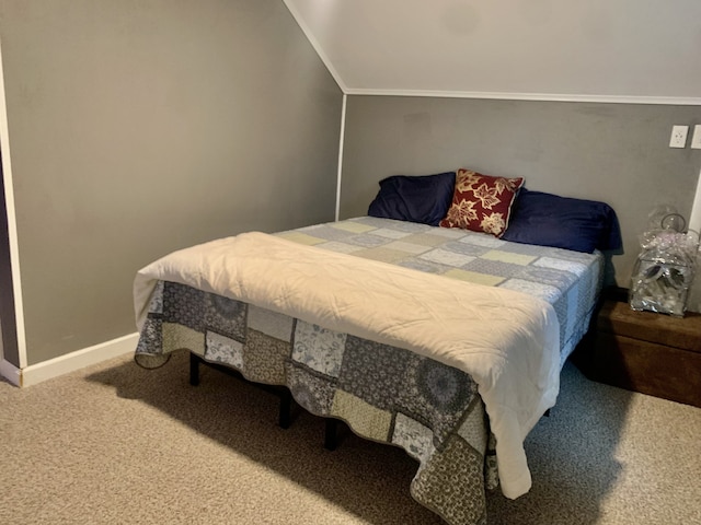 bedroom with lofted ceiling and carpet flooring