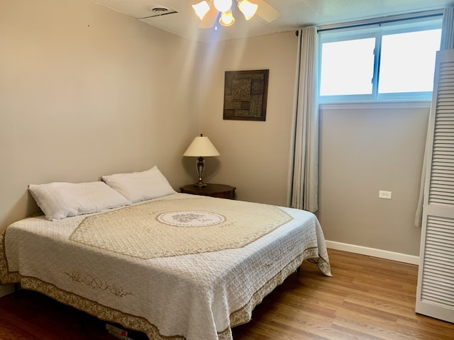 bedroom with ceiling fan and hardwood / wood-style floors