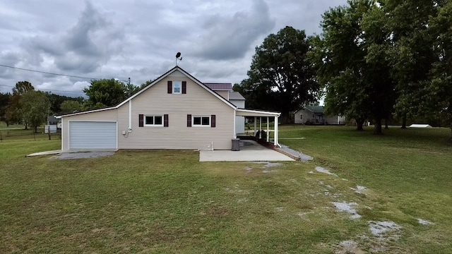 back of house featuring a lawn and a patio area