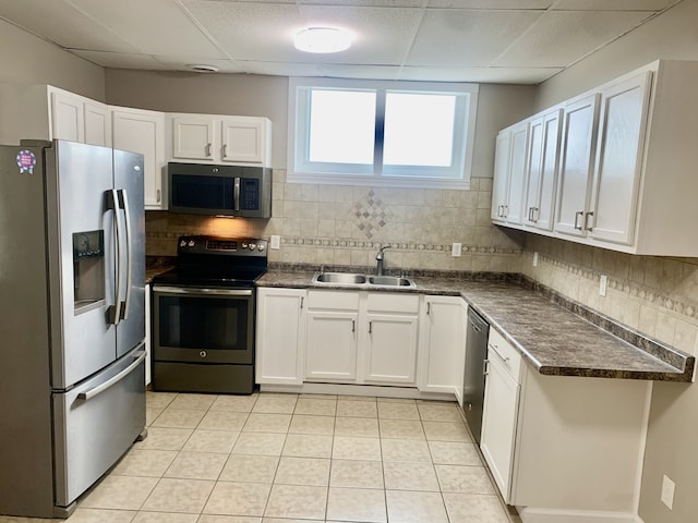 kitchen featuring white cabinets, appliances with stainless steel finishes, sink, and tasteful backsplash