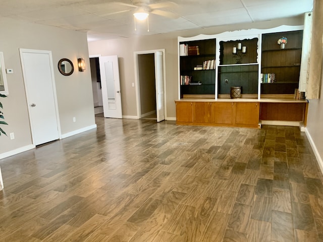 unfurnished living room with ceiling fan and dark hardwood / wood-style floors