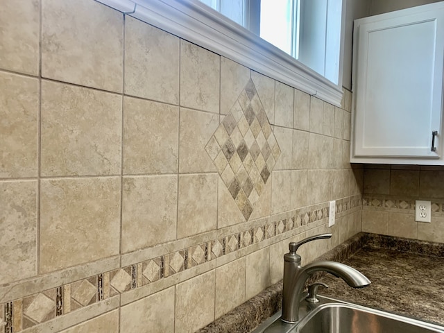 room details with white cabinets and sink