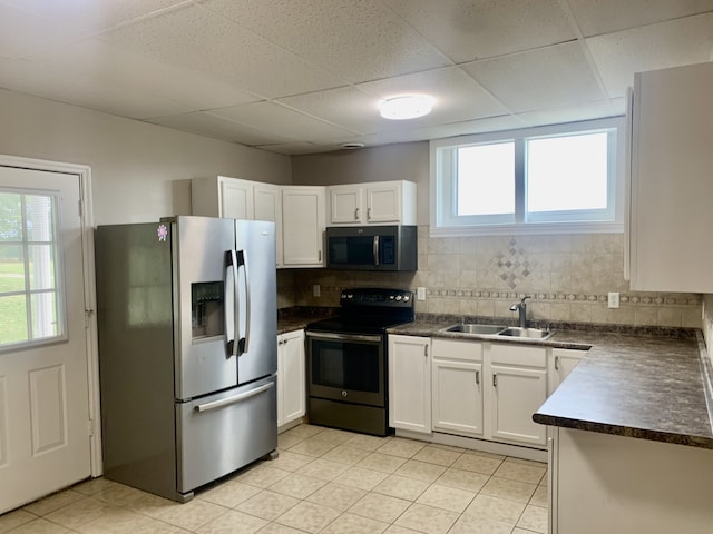 kitchen with white cabinets, appliances with stainless steel finishes, sink, and a healthy amount of sunlight