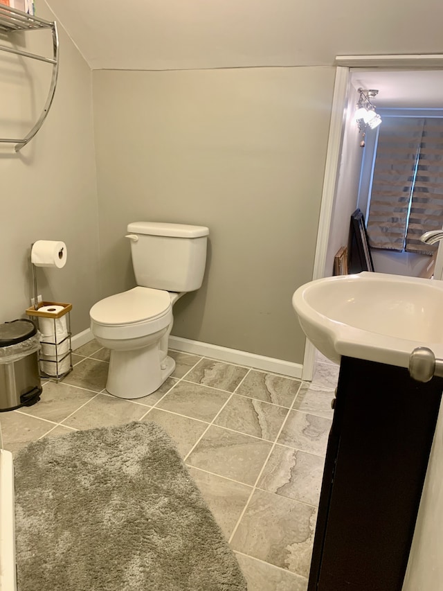 bathroom with vanity, tile patterned flooring, and toilet