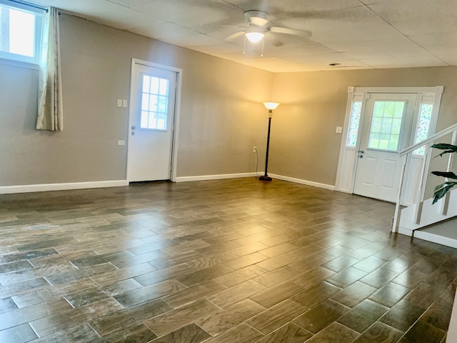 entrance foyer with a healthy amount of sunlight, dark hardwood / wood-style flooring, and ceiling fan