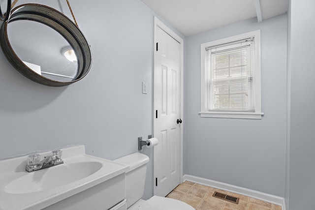 bathroom featuring tile patterned floors, vanity, and toilet