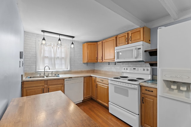 kitchen with backsplash, white appliances, light wood-type flooring, decorative light fixtures, and sink