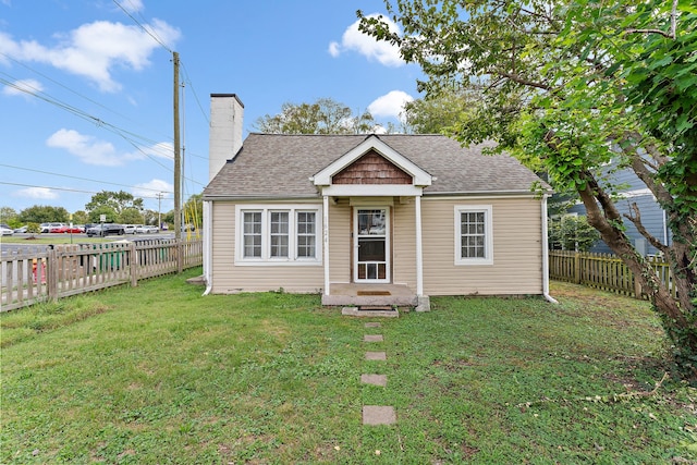 bungalow-style home featuring a front yard