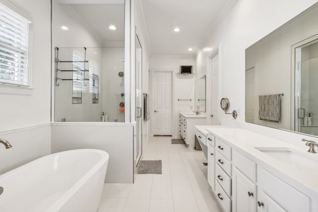 bathroom featuring vanity, shower with separate bathtub, ornamental molding, and tile patterned floors