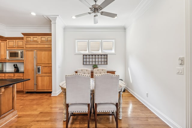 dining area with light wood-type flooring, ornamental molding, and ceiling fan