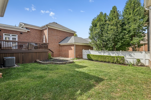 view of yard featuring central air condition unit and a wooden deck