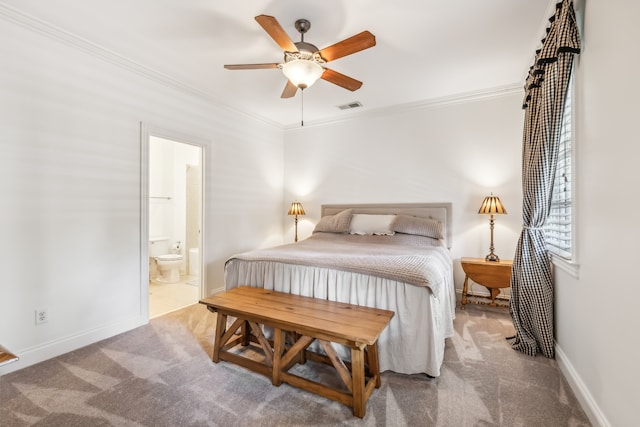 bedroom with ceiling fan, connected bathroom, crown molding, and light carpet