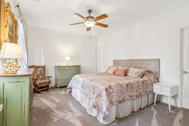 carpeted bedroom featuring crown molding and ceiling fan