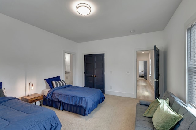 carpeted bedroom featuring ensuite bathroom