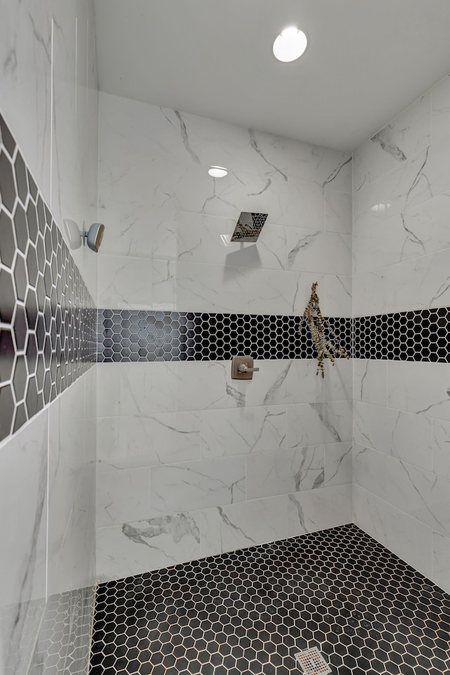 bathroom with a tile shower