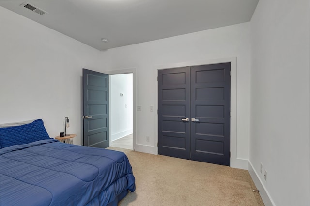 carpeted bedroom with a closet