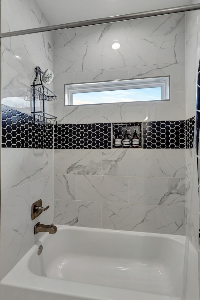 bathroom featuring tiled shower / bath and a healthy amount of sunlight