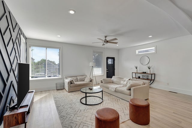 living room featuring light wood-type flooring and ceiling fan