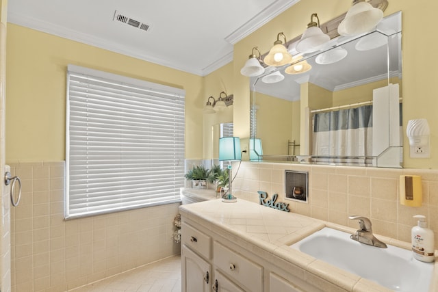 bathroom with tile walls, tile patterned flooring, plenty of natural light, and vanity