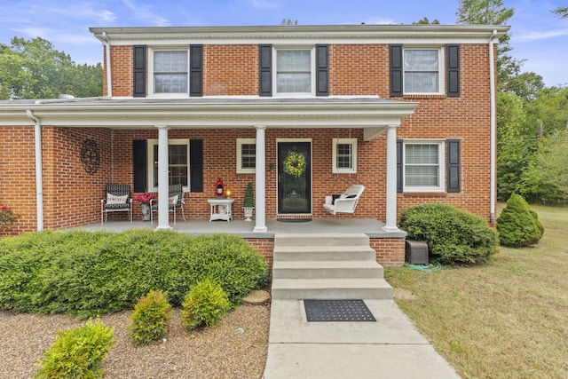 view of front of home featuring a front yard and a porch