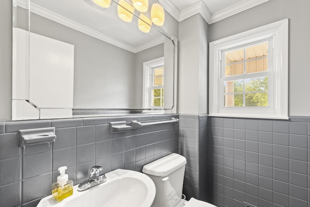 bathroom with a healthy amount of sunlight, tile walls, and toilet