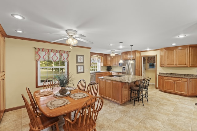 dining space featuring crown molding, light tile patterned floors, and ceiling fan