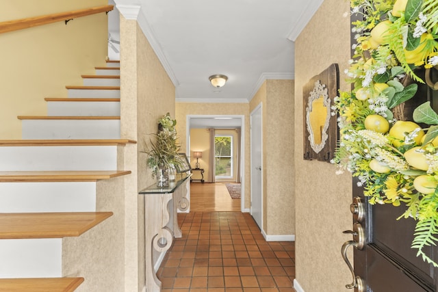 hall with dark tile patterned flooring and ornamental molding