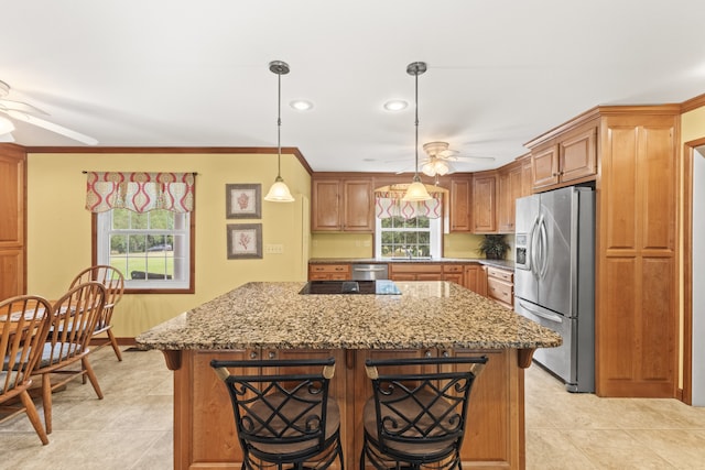 kitchen featuring ceiling fan, appliances with stainless steel finishes, and plenty of natural light