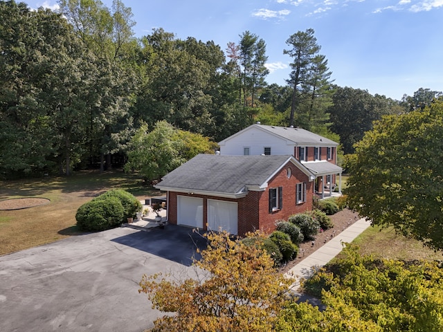 view of front of house with a garage and a front lawn