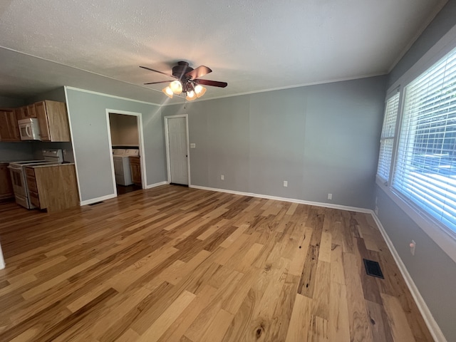 unfurnished living room with ceiling fan, a textured ceiling, crown molding, and light hardwood / wood-style floors