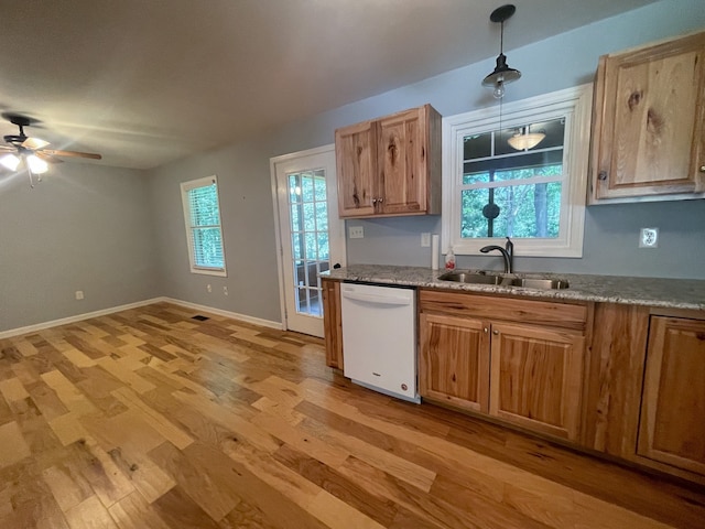 kitchen with hanging light fixtures, white dishwasher, ceiling fan, light hardwood / wood-style flooring, and sink