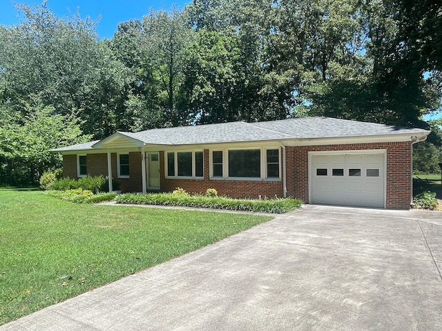 single story home featuring a garage and a front yard