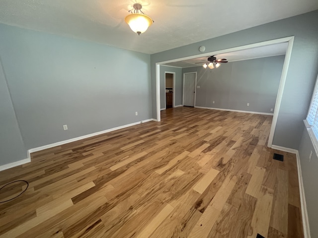 empty room with light hardwood / wood-style floors and ceiling fan