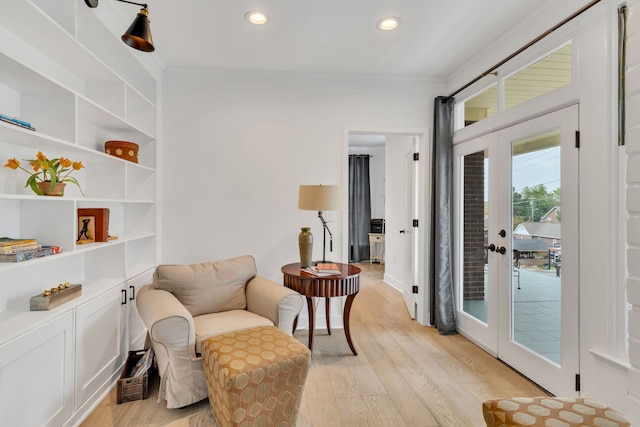 living area with french doors and light wood-type flooring