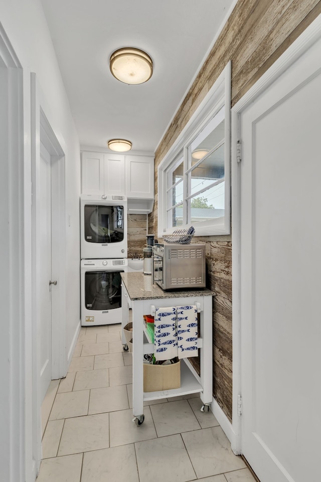 kitchen featuring white cabinets, light tile patterned flooring, oven, and stone countertops